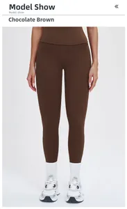 Detail of high-waisted chocolate brown yoga pants paired with white socks and sneakers