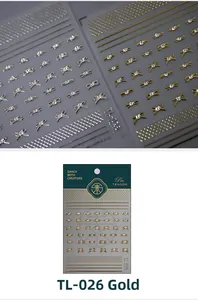 Macro detail of 5D gold bow nail stickers with rhinestones and grid patterns on card