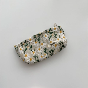 Detailed view of the daisy embroidery and fabric texture on this minimalist pouch