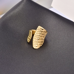 Detail of 18K gold plated ring featuring snake skin texture and adjustable band