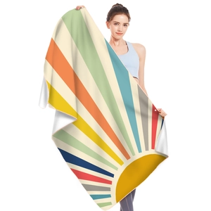 Detail of soft microfiber beach towel with vintage sunburst pattern and edge stitching