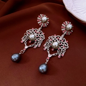Detail of vintage silver earrings with water-drop gray pearls and pink rhinestones