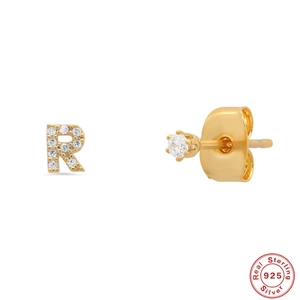 Close-up of S925 sterling silver gold stud with crystal letter R and a round diamond