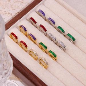 Elegant gold and silver huggie earrings with colorful baguette-cut cubic zirconia crystals