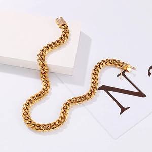 Close-up of 12mm gold Cuban link necklace with crystal-encrusted clasp on white background