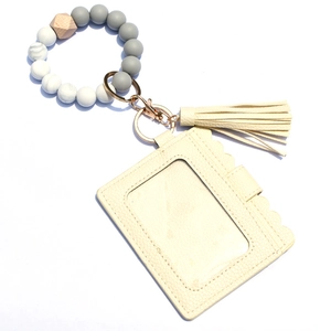 Detail of silicone bead wristlet with marble texture, fringe tassel and PU leather card holder