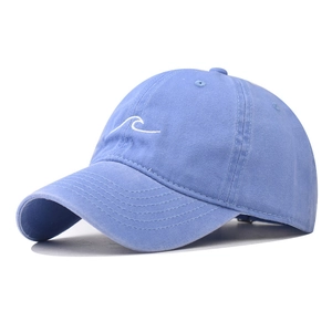 Detail of light blue washed cotton baseball cap featuring white wave line embroidery