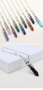 Detail view of hexagonal crystal pendulum with ornate silver-toned hollow filigree cap