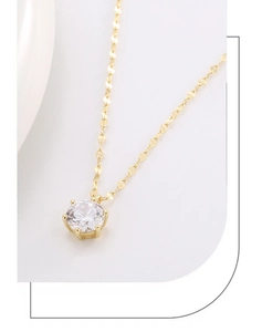 Close-up of golden petal chain with sparkling round white gemstone in four-prong setting
