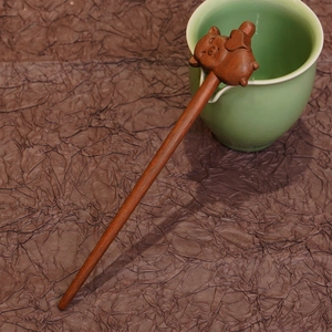 Detailed carving of a lucky pig on a premium sandalwood hair stick for elegant styling