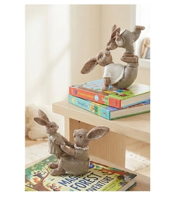 Close-up of resin rabbit figurines showing hand-painted texture on a wooden desk