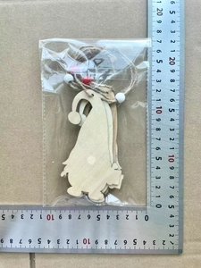 Close-up of wooden Christmas gnome ornament with ruler showing 11cm height and red beads