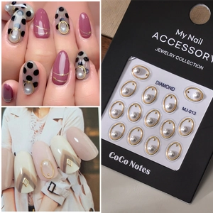 Detailed view of MJ-013 gold oval metal nail charms with elegant faux white pearls