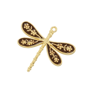Detail of dragonfly pendant with gold metal floral patterns and brown enamel wings