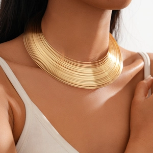 Detail view of a metallic gold multilayer wide choker necklace on a female model