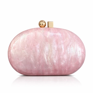 Close-up of pink acrylic shell bag featuring marble texture and gold metal clasp detail