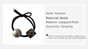 Detail of leopard print resin bead and silver sphere on elastic hair tie for ponytails