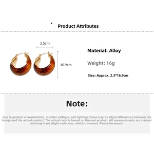 Detail view of U-shaped amber resin hoop earrings with gold alloy inner lining