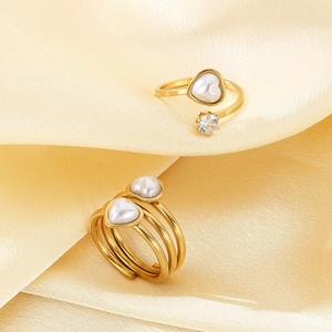 Close-up of gold-plated stainless steel ring featuring heart-shaped pearl and zircon accents