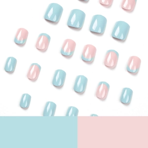 Short square false nails in blue French tip and light pink design on white background