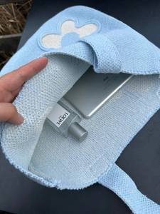 Internal view of light blue knitted tote bag showing spacious storage for daily items