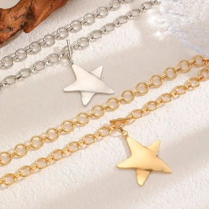 Detail view of pentagram star pendant necklaces with OT toggle clasp in gold and silver finish