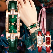 Detail of rectangular women's watch with gold casing and green leather strap accents