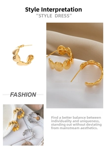 Detail view of C-shaped hoop earrings featuring high-polish golden and silver finish textures