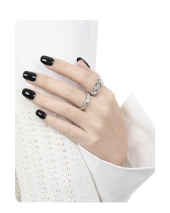 Detail of silver rings featuring irregular wave patterns and cubic zirconia on model