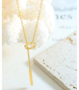 Detail of 18k gold plated titanium OT buckle necklace with a geometric bar pendant