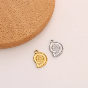 Detail of conch shell charms in gold and silver finish for DIY jewelry making