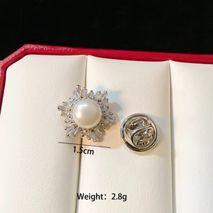 Detail view of 1.5cm shell butterfly brooch with pearls and crystals on a gift box