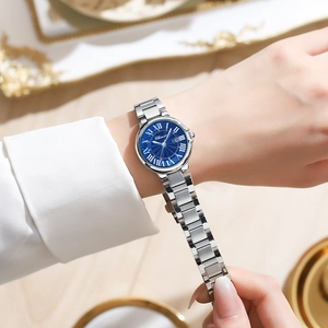 Close-up of a women's quartz watch with blue sunray dial and silver stainless steel strap