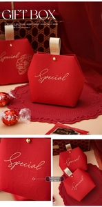 Detail of red hexagonal gift box featuring gold foil lettering and textured embossing