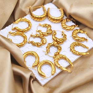 Gold plated stainless steel croissant hoop earrings set on champagne silk background