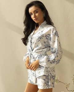 Detail of blue floral satin loungewear set featuring long sleeve wrap top and matching shorts