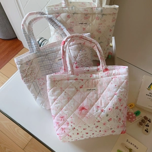 Three quilted cotton tote bags with floral patterns and 'simple wish' fabric labels