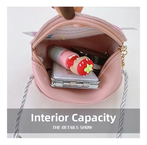 Detail showing inner capacity of pink round mini crossbody bag for kids with small items