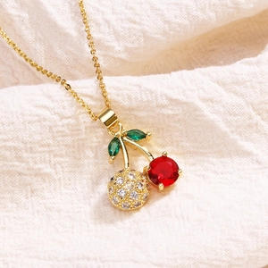 Minimalist hand-painted cherry pendant necklace with red crystals on a gold chain