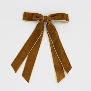 Detail shot of vintage brown double-layered velvet hair bow with long elegant ribbons