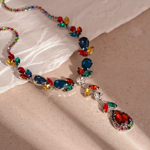 Detailed close-up of teardrop-shaped multicolor crystals on a silver necklace