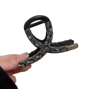 Elegant black hair claw clip with charcoal grey rhinestones shown on white background