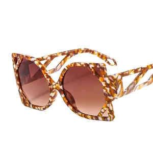 Avant-garde cat eye sunglasses with oversized tortoise shell frame and hollow temples