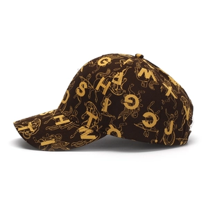 Macro detail of retro brown baseball cap with golden letter prints and illustrations