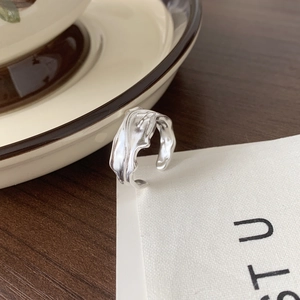 Detailed macro view of 925 sterling silver ring with irregular liquid metal lava texture