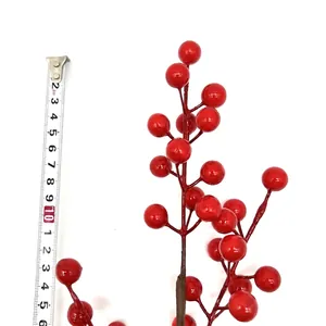 Artificial red holly berry branch for festive decor with clear tape measure scale