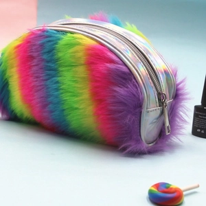 Rainbow plush makeup bag and pencil case with holographic silver details on blue background