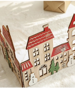 Detail of wooden Christmas fence with houses and snowmen featuring glitter finish texture