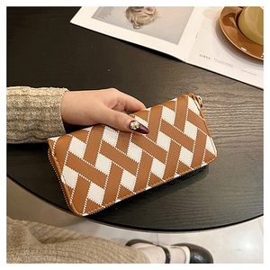 Close-up of long women's wallet featuring brown and white woven leather texture