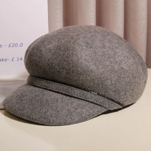 Detailed view of dark grey wool newsboy hat with black sequin ribbon trim for autumn